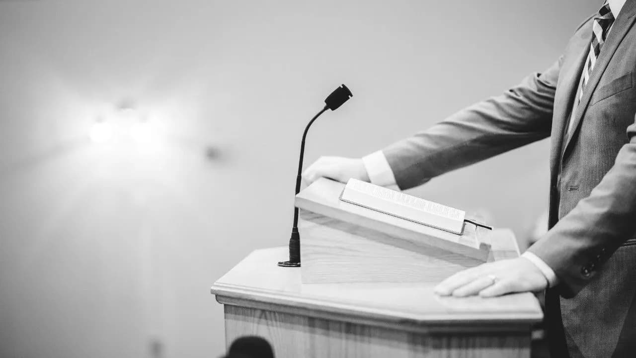 photologuephotos2025-03grayscale-shot-male-speaking-podium_1_0jpg photologuephotos2025-03grayscale-shot-male-speaking-podium_1_0jpg