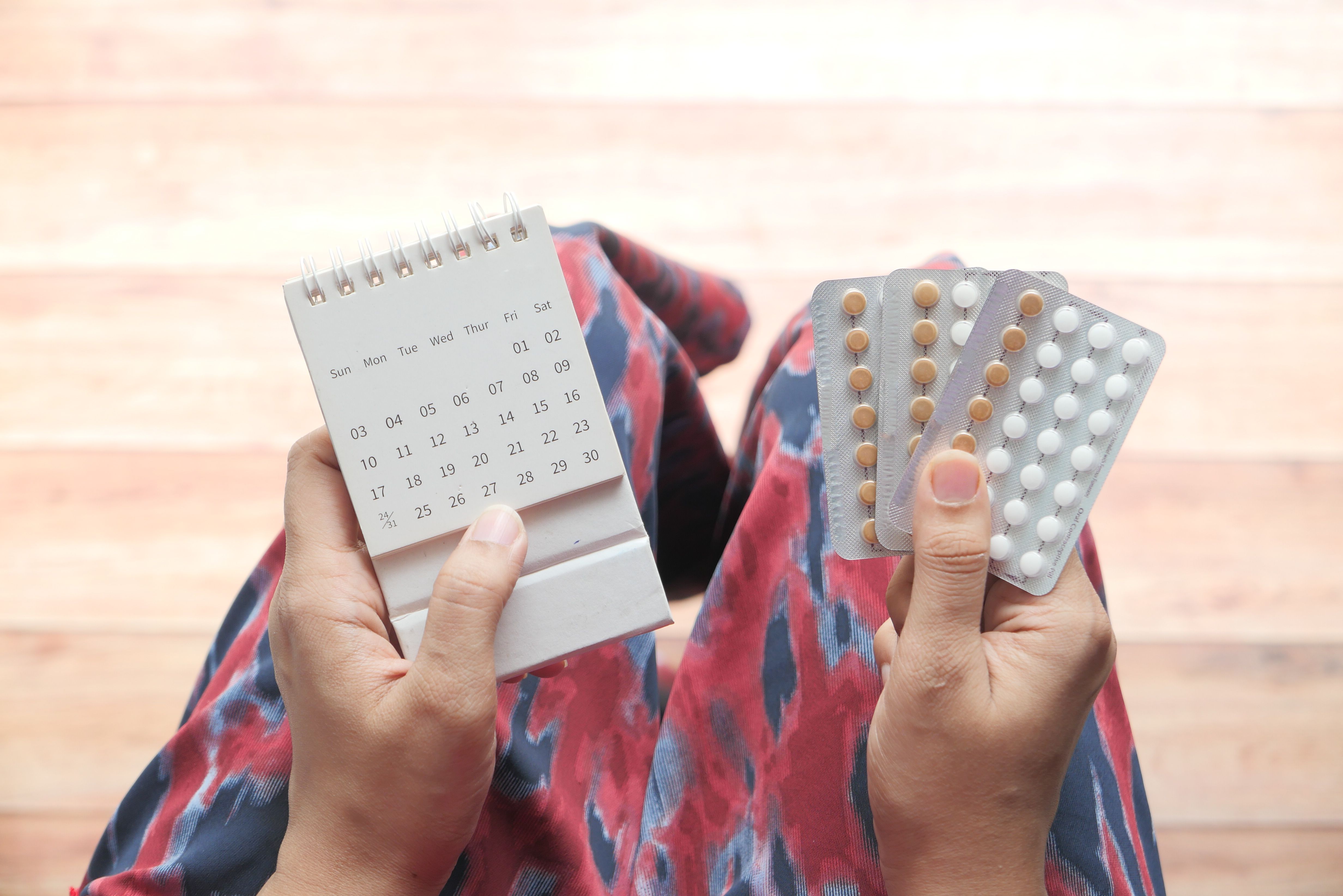 women-hand-golding-birth-control-pills-calendar.jpg