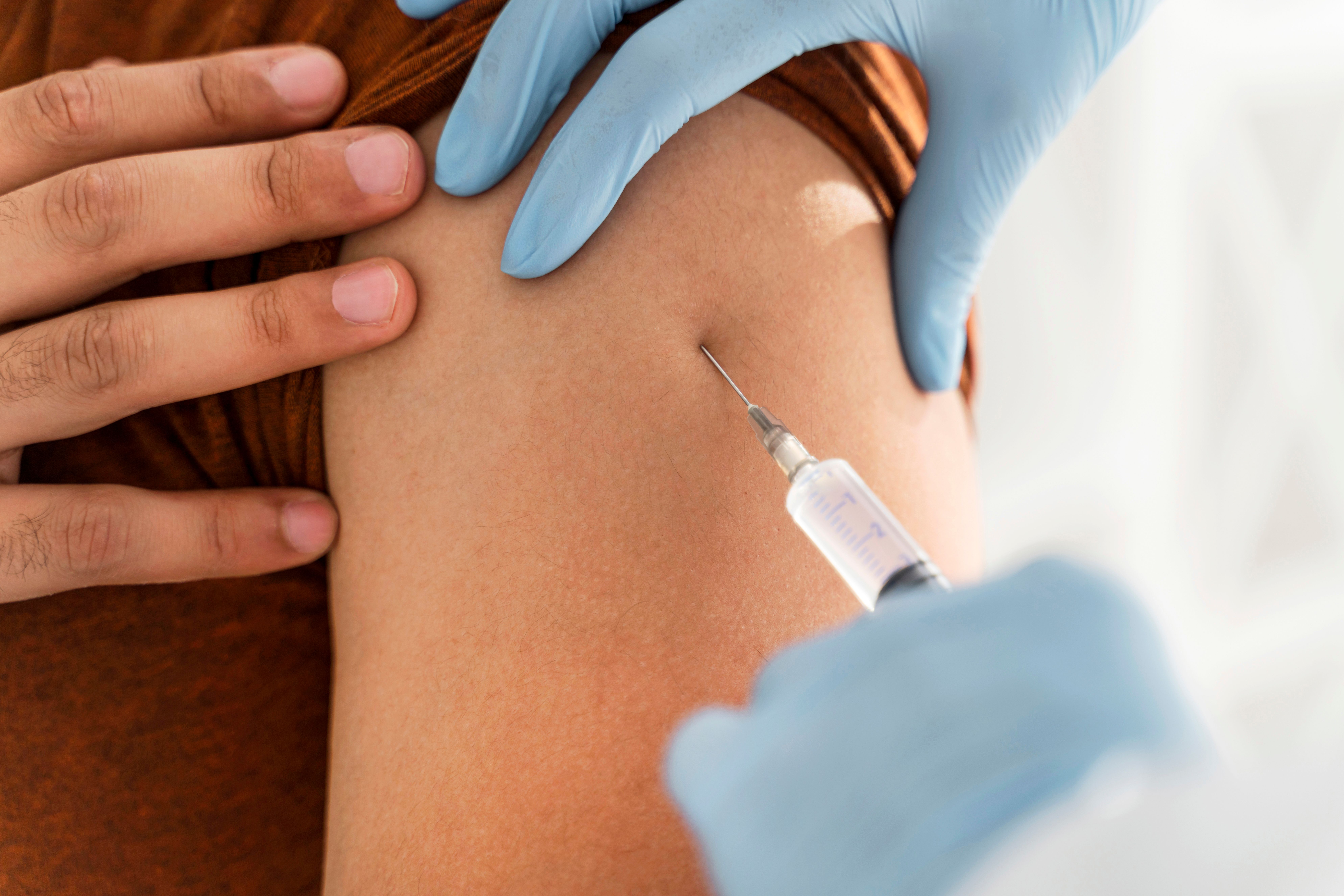 close-up-man-being-vaccinating-by-doctor.jpg