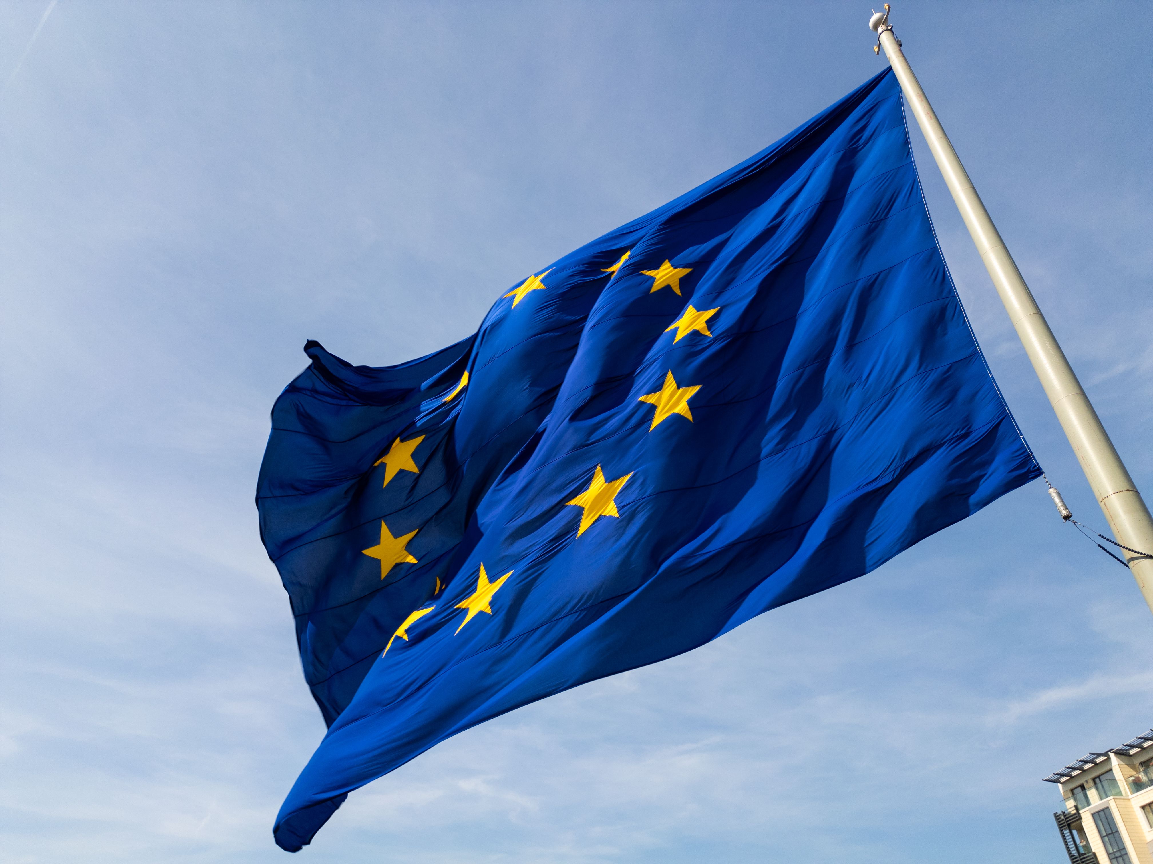 closeup-shot-european-union-flag-waving-wind-with-its-iconic-blue-background.jpg