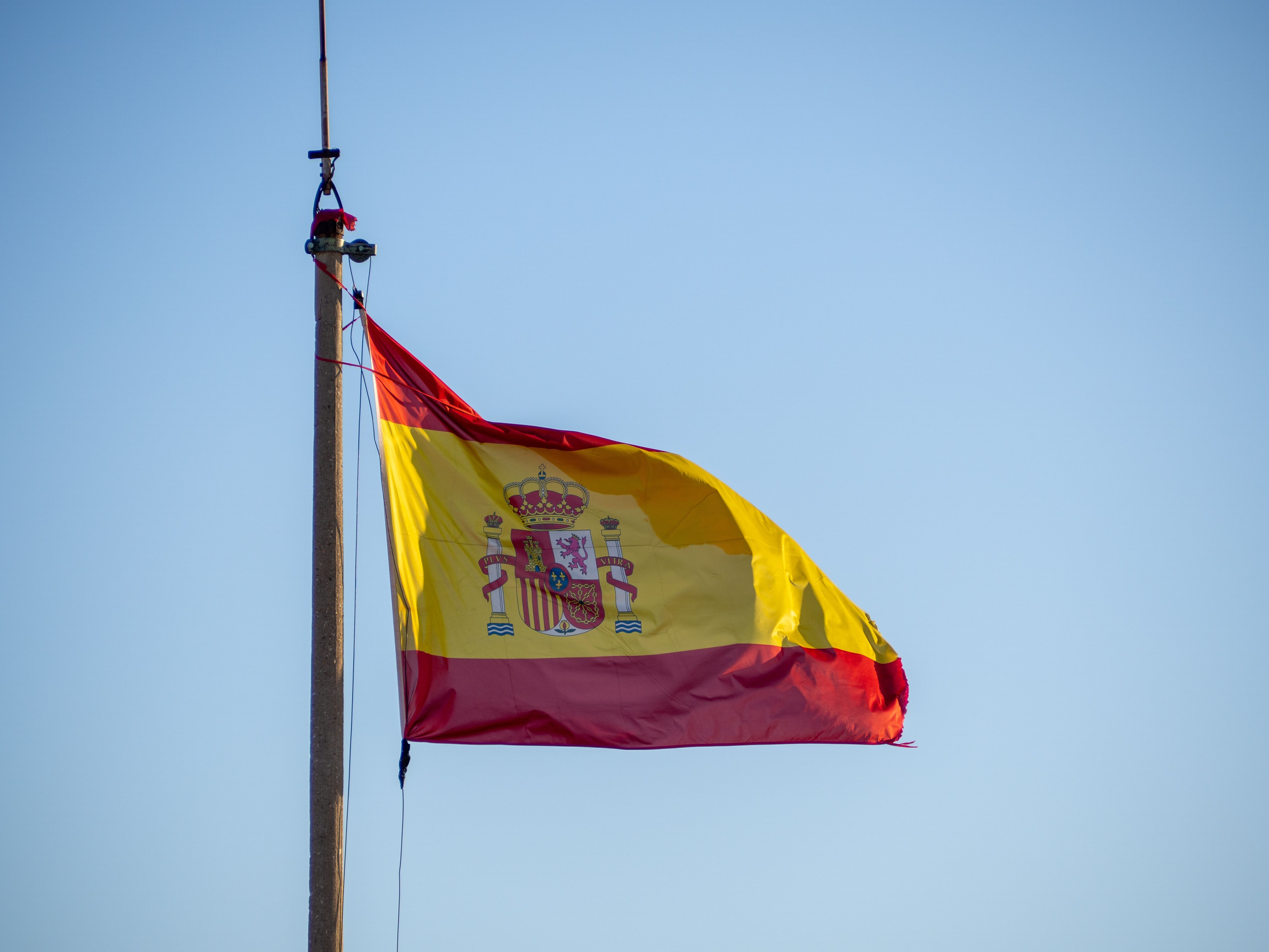 national-flag-spain-waving-flagpole-clear-blue-sky.jpg