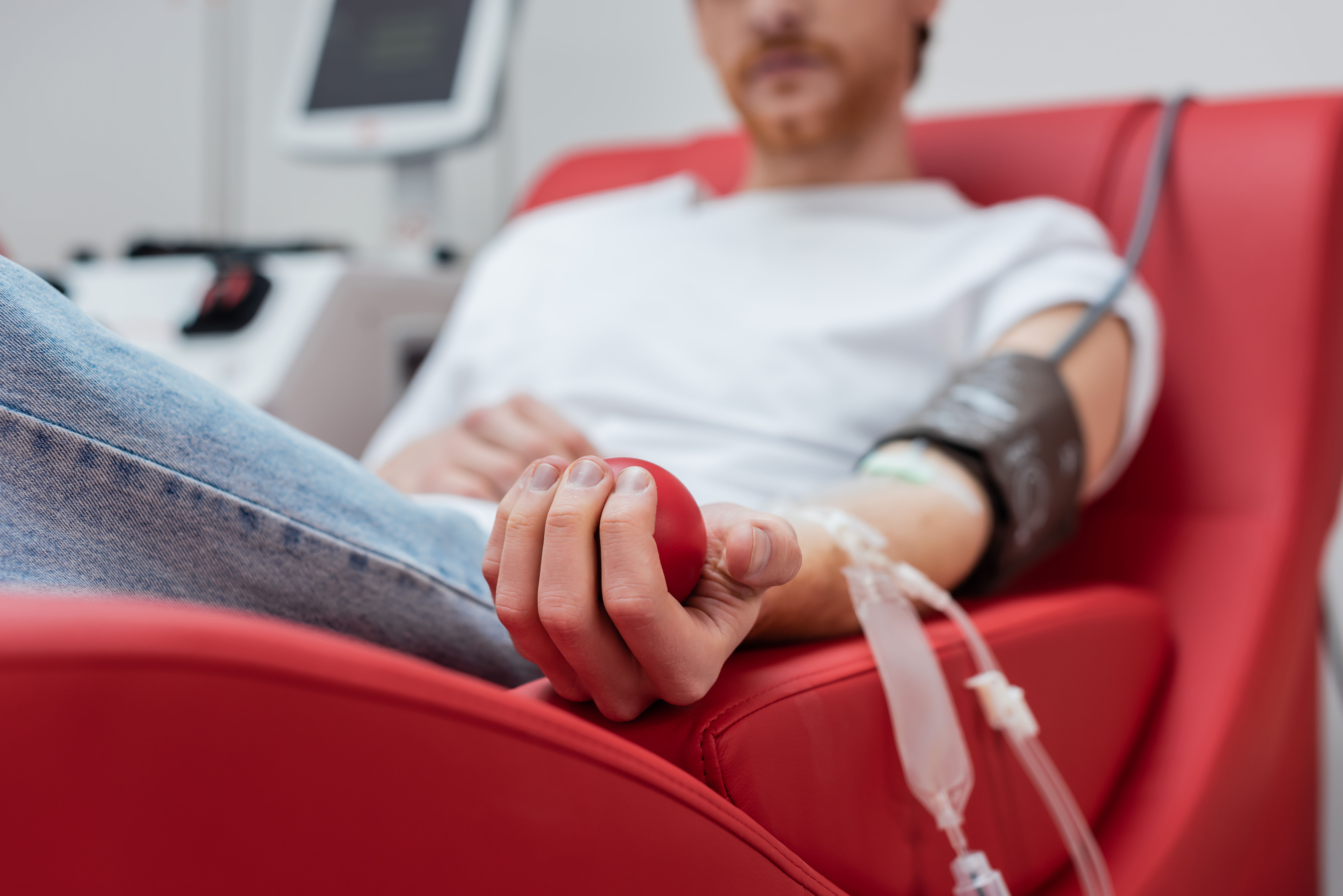 selective-focus-rubber-ball-hand-cropped-volunteer-with-transfusion-set-sitting.jpg